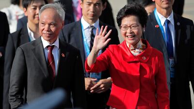 Hong Kong Chief Executive-elect Carrie Lam, right, walks with her husband Lam Siu-por as she waves to guests before attending the flag raising ceremony to mark the 20th anniversary of the Hong Kong handover to China in Hong Kong, Saturday, July 1, 2017. (AP Photo/Vincent Yu)