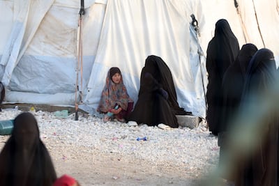 A woman and child, relatives of suspected ISIS fighters, at Al Hol camp in the desert region of Hasakah province in Syria. AFP