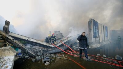 Firefighters inspect after a fire at a storage site in Baghdad, housing the boxes from Iraq's May parliamentary election, Iraq June 10, 2018. Thaier Al-Sudani / Reuters