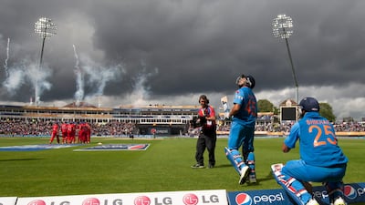 But players returned after a short while with the opening batsmen Rohit Sharma, second right, and Dhawan getting back on the field. Jon Super / AP Photo