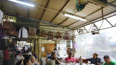 Patrons share the day's news at Xin Long Cheng cafe. Peter Yeung for The National