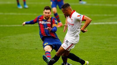 Barcelona attacker Lionel Messi was booked for this tackle on Sevilla's Fernando. Reuters