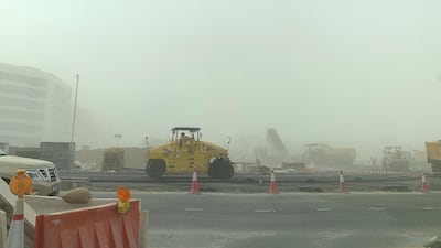 Construction workers during the sandstorm in Dubai Investment Park area in Dubai. Pawan Singh / The National