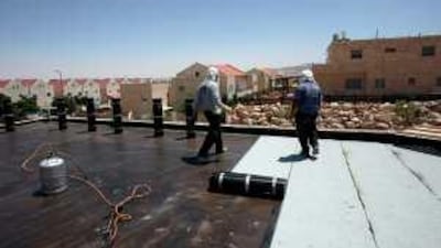 Workers are continuing to build new houses at the Israeli West Bank settlement of Adam, north of Jerusalem.