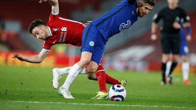 Liverpool's Ozan Kabak, left, challenges for the ball with Chelsea's Jorginho. AP