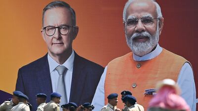Police stand next to a poster of Anthony Albanese and Narendra Modi in Ahmedabad. AFP