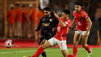 Al Ahly's Emam Ashour tackles Al Ain's Mohamed Abbas. Reuters