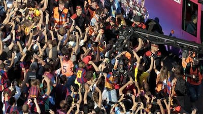 Barcelona’s players celebrate with supporters their UEFA Champions League title during an open top bus parade through the streets of Barcelona city, northeastern Spain, 07 June 2015. Barcelona clinched a fifth European champions title with a 3-1 victory over Juventus in the UEFA Champions League final in Berlin on 06 June 2015. EPA/ALBERTO ESTEVEZ