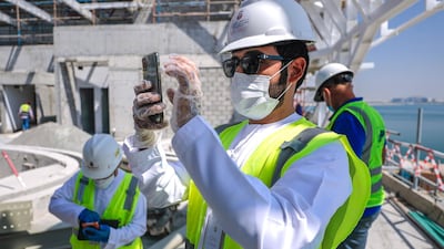 Faraj Ali Almaeeni, an inspector of the Health and Safety Department checks for any slip-ups around scaffolds. Victor Besa / The National