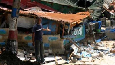 Papa Yansane says he is jobless as points to the broken-down Paradise bar in Freetown.