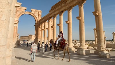 Tourists ride camels in Palmyra, a Unesco World Heritage Site in Syria. AFP