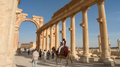 Tourists ride camels in Palmyra, a Unesco World Heritage Site in Syria. AFP