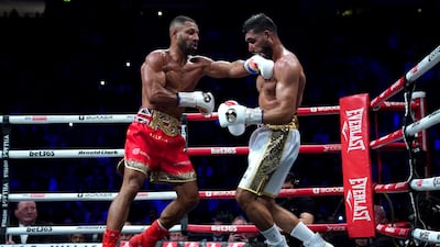Kell Brook, left, lands a punch on Amir Khan. PA