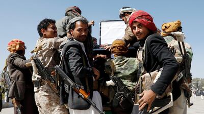 Armed Houthi fighters ride a vehicle as they attend a funeral procession for slain Houthi fighters in Sanaa, Yemen, February 28, 2021. EPA