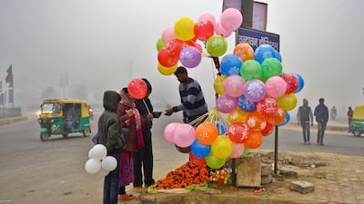 A man sells balloons at a traffic roundabout in Greater Noida, outskirts of New Delhi, India. RS Iyer / AP Photo