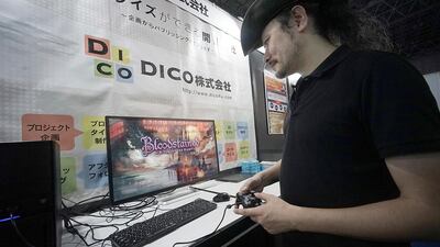 Game creator Koji Igarashi plays a new game called "Bloodstained: Ritual of the Night" while speaking during an interview at the Tokyo Game Show. Eugene Hoshiko / AP Photo