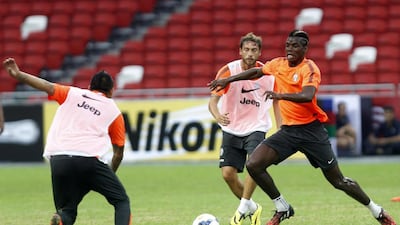 Juventus player Paul Pogba, right, trains with teammates ahead of their match against a Singapore XI in the Far East. Edgar Su/ Reuters