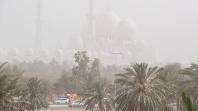 Sheikh Zayed Grand Mosque viewed through a haze of sand and dust in Abu Dhabi. Winds reached speeds of up to 40 kilometres per hour. Victor Besa / The National