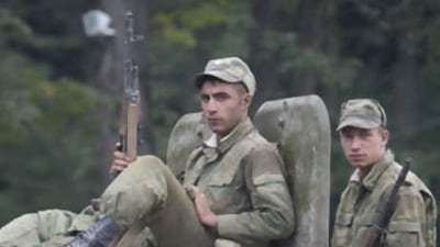Russian soldiers ride aboard an armoured vehicle near Alagir, North Ossetia, on the road to the border of South Ossetia yesterday.