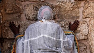 An Orthodox Christian prays outside the Church of the Holy Sepulchre during a Good Friday procession on the Via Dolorosa in Jerusalem's Old City. EPA