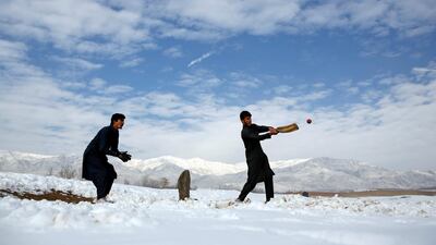 Afghan men play cricket on a field covered in snow on the outskirts of Kabul, Afghanistan. Mohammad Ismail / Reuters