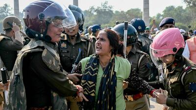 Police detain a supporter of varied farmer unions during a sit-in protest at the Delhi-Uttar Pradesh state border in Noida. AFP