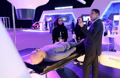 Chadi Mishlawi, facility manager at the Neuro Spinal Hospital, explains how CyberKnife Accuracy surgery machine works to visitors at the Dubai Health Forum. Pawan Singh / The National