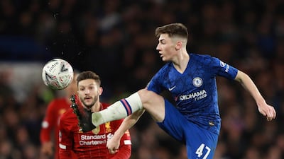 Billy Gilmour, right, controls the ball in front of Liverpool midfielder Adam Lallana AP Photo