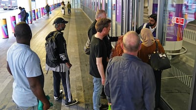 Passengers wait to board a train at Birmingham New Street. PA