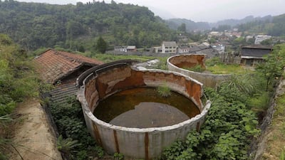 Two disused tanks are seen at a closed realgar mining plant at Heshan village. Jason Lee / Reuters