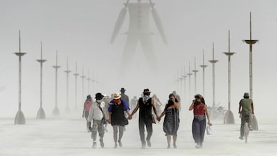 Burning Man participants walk through dust at the annual Burning Man event on the Black Rock Desert of Gerlach, Nev. Organisers call Burning Man the largest outdoor arts festival in North America, with its drum circles, decorated art cars, guerrilla theatrics and colourful theme camps. Andy Barron / AP