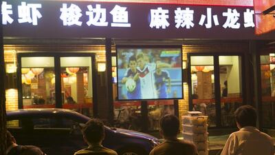 Chinese football fans watch a broadcast of the Fifa World Cup 2014 final. The governing body has extended the rights for CCTV to cover the next two events. Rolex Dela Pena/ EPA