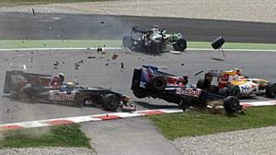 Toro Rosso's Sebatian Buemi, teammate Sebastien Bourdais, Force India's Adrian Sutil and Renault's Nelson Piquet crash at the Circuit de Catalunya at the start of the Spanish Grand Prix