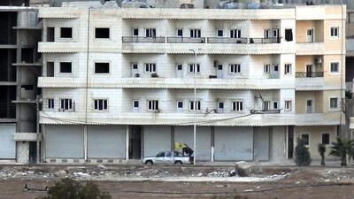 Taken from a hilltop in Mursitpinar on the outskirts of Suruc at the Turkey-Syria border, this photo taken on October 19 shows Kurdish fighters driving a machine gun-fitted pick-up truck, with the flag of The People’s Protection Units – or YPG – the main Kurdish militia in Syria. Levend Ali/AP Photo