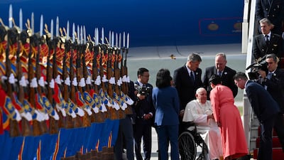 The Pope was greeted by Mongolian honour guards wearing traditional blue, red and yellow attire. AFP