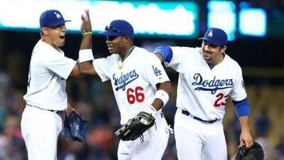 Yasiel Puig, centre, has electrified fans at Dodger Stadium with his bat and his glove.