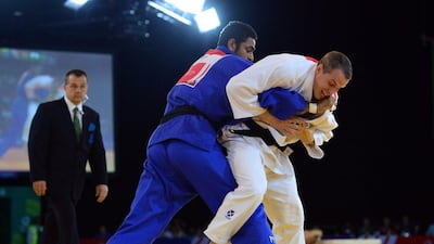 Pakistan's Shah Hussain, left, won silver at the 2014 Commonwealth Games in judo. Carl Court / AFP