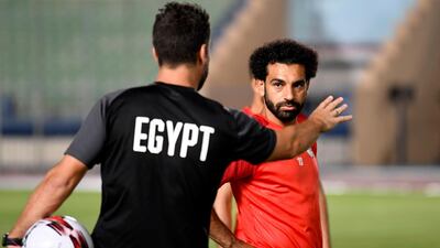 Salah listens to a coach during a training session. AFP