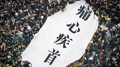 Protesters hold banners and shout slogans as they march on a stree in Hong Kong China. Large numbers of protesters rallied on Sunday despite an announcement yesterday by Hong Kong's Chief Executive Carrie Lam that the controversial extradition bill will be suspended indefinitely. Getty Images