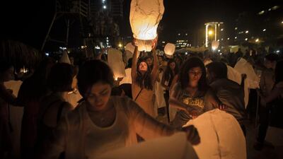 A young Lebanese woman launches a lantern during the third Lebanon Lantern Festival on a beach in Beirut, Lebanon. Oliver Weiken / EPA