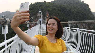 A visitor takes a selfie on the bridge. Authorities are hoping it will attract tourists after months of Covid-19 closures.