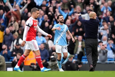 Manchester City's Bernardo Silva and manager Pep Guardiola embrace after the 2-1 win over Arsenal. PA