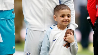 Bradley Lowery stands in Wembley Stadium, London, while holding the hand of his hero, England's Jermain Defoe (AP Photo/Kirsty Wigglesworth)