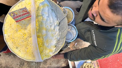 Adesh Kumar, 26, a fourth-generation confectioner, sells the popular Daulat ki Chaat, a delicate dessert, in the old quarters of Delhi. Taniya Dutta / The National