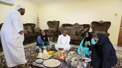 Umm Saif, second left, with, from left, her sons Ali Saeed and Saif, and her daughters Najla Saeed and Mouza, at the majlis area of the family home in Hatta in Dubai. Pawan Singh / The National