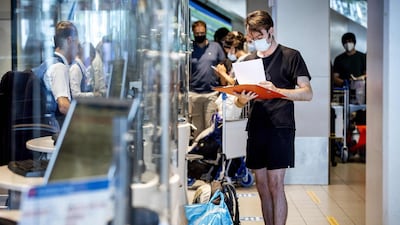 Travellers check in at a KLM counter at Amsterdam's Schiphol Airport. AFP