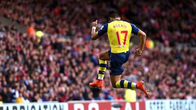 Alexis Sanchez of Arsenal celebrates after scoring the opening goal during the English Premier League match against Sunderland at the Stadium of Light on October 25, 2014, in Sunderland, England. Michael Regan / Getty Images