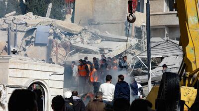 Emergency workers search for survivors under the rubble of the collapsed building. AFP