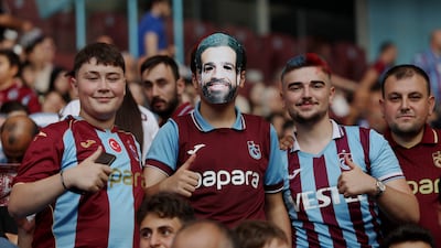 A Trabzonspor fan wears a Mohamed Salah mask. Reuters
