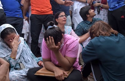 Sakshi Malik, an Indian wrestler who won a bronze medal at the 2016 Summer Olympics, sits with fellow wrestlers by the banks of the river Ganges in Haridwar, India, in May. AP